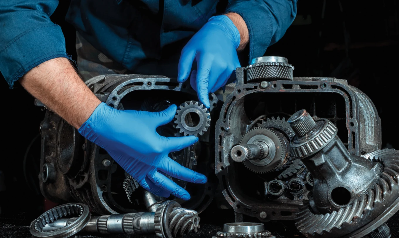 Technician working beside an open transmission case